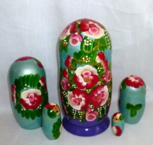Ksenia in floral blue dress nesting Doll Babooshki s