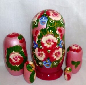 Ksenia in floral red dress nesting Doll Babooshki s