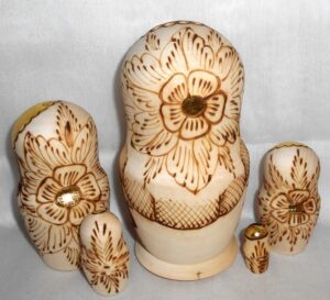 Girl with plait & red bow nesting Doll Babooshki s