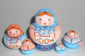 Village girl in traditional dress in blue small babushka Babushka Matryoshka nesting Doll Babooshki Babushkas