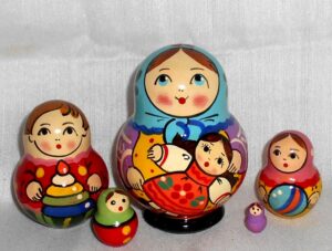 Village girl with self-made doll blue scarf Babushka Matryoshka nesting Doll Babooshki Babushkas Classic Village Traditional