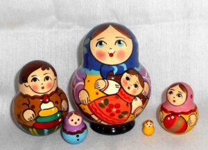 Village girl with self-made doll dark blue scarf Babushka Matryoshka nesting Doll Babooshki Babushkas Classic Village Traditional