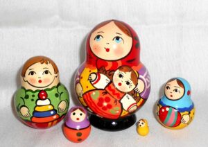 Village girl with self-made doll green dress red scarf Babushka Matryoshka nesting Doll Babooshki Babushkas Classic Village Traditional