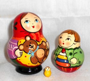 Village girl with teddy bear green dress red scarf nesting Doll Babooshki s Classic Village Traditional