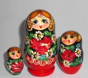Girl in red & black floral dress nesting Doll Babooshki s