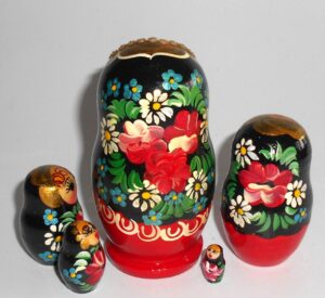 Girl in red & black floral dress nesting Doll Babooshki s
