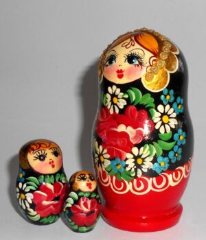 Girl in red & black floral dress nesting Doll Babooshki s