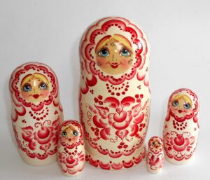 Girl in white and red Babushka Matryoshka nesting Doll Babooshki Babushkas