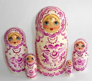 Girl in white and purple Babushka Matryoshka nesting Doll Babooshki Babushkas