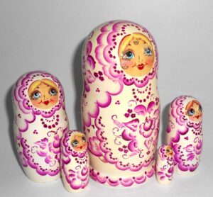 Girl in white and purple nesting Doll Babooshki s