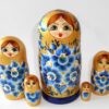 Girl in golden dress with blue flowers Babushka Matryoshka nesting Doll Babooshki Babushkas