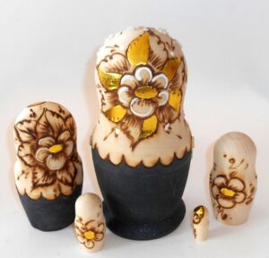 Village girl with gold flowers nesting Doll Babooshki s