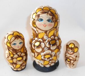 Village girl with gold flowers nesting Doll Babooshki s