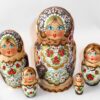 Village girl with red flowers on apron Babushka Matryoshka nesting Doll Babooshki Babushkas