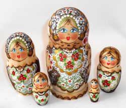 Village girl with red flowers on apron Babushka Matryoshka nesting Doll Babooshki Babushkas