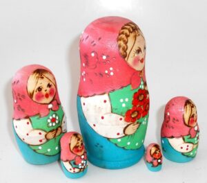 Village girl with plait and red flowers pink scarf nesting Doll Babooshki s