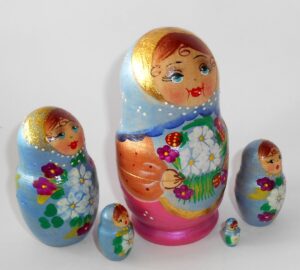 Girl in blue scarf gold apron nesting Doll Babooshki s