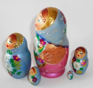 Girl in blue scarf gold apron nesting Doll Babooshki s