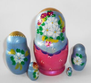 Girl in blue scarf gold apron nesting Doll Babooshki s