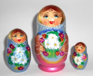Girl in blue scarf gold apron nesting Doll Babooshki s
