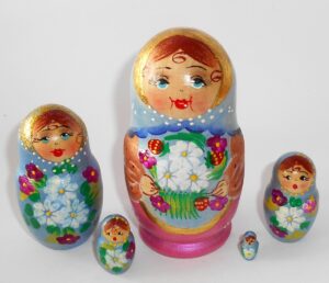 Girl in blue scarf gold apron Babushka Matryoshka nesting Doll Babooshki Babushkas